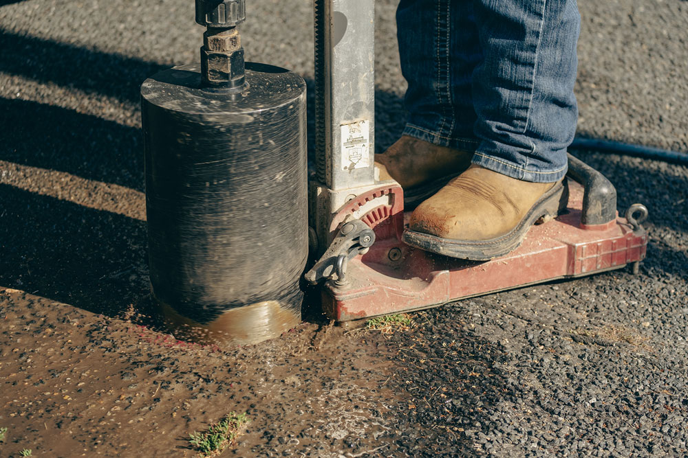 Safe Site worker about to drill a hole in the ground