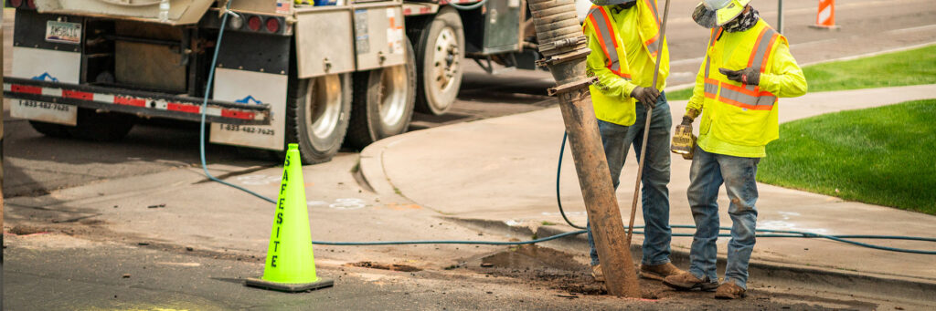 Safe site workers using hydrovac excavation to dig a hole